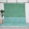 Minimalist Moroccan rug hand-knotted in forest green and soft aqua blue, made from 100% wool by Berber artisans.