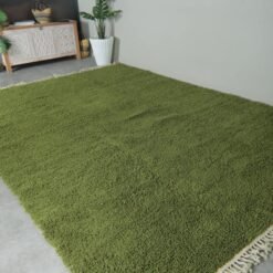 Moroccan olive green Beni Ourain rug showing its clean lines, deep earthy color, and handwoven texture. Perfect for floor styling or as an artistic wall hanging.