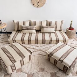 Bohemian living room with Moroccan floor sofa set in cream and brown, styled with rugs and plants