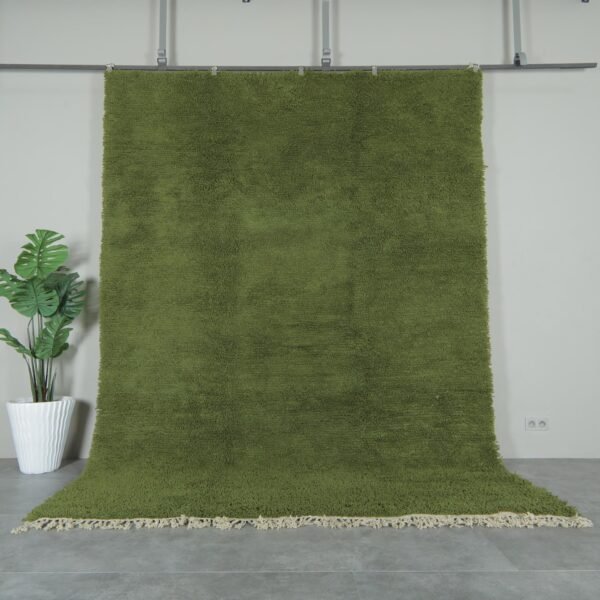 Authentic handmade Moroccan olive green Beni Ourain rug crafted with 100% natural lamb’s wool by skilled Berber women artisans. This lush olive green wool rug adds earthy elegance and cultural warmth to modern and rustic interiors. Perfect for living rooms, bedrooms, and wall décor.