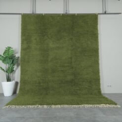 Authentic handmade Moroccan olive green Beni Ourain rug crafted with 100% natural lamb’s wool by skilled Berber women artisans. This lush olive green wool rug adds earthy elegance and cultural warmth to modern and rustic interiors. Perfect for living rooms, bedrooms, and wall décor.