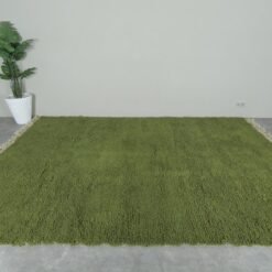 hand-knotted Moroccan olive green Beni Ourain rug showcasing the rich wool texture and plush pile. Handmade in the Atlas Mountains, this rug brings natural color and artisan quality to your home decor.