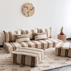 Set of Moroccan sofa pillows arranged on cream and brown floor cushion