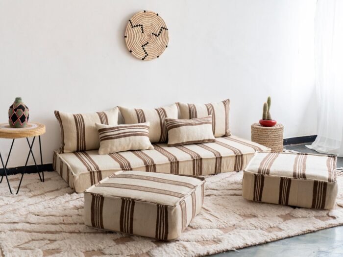 Set of Moroccan sofa pillows arranged on cream and brown floor cushion
