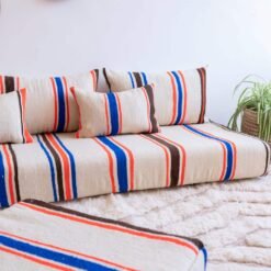 Artisan working on embroidered stripes in Moroccan wool fabric