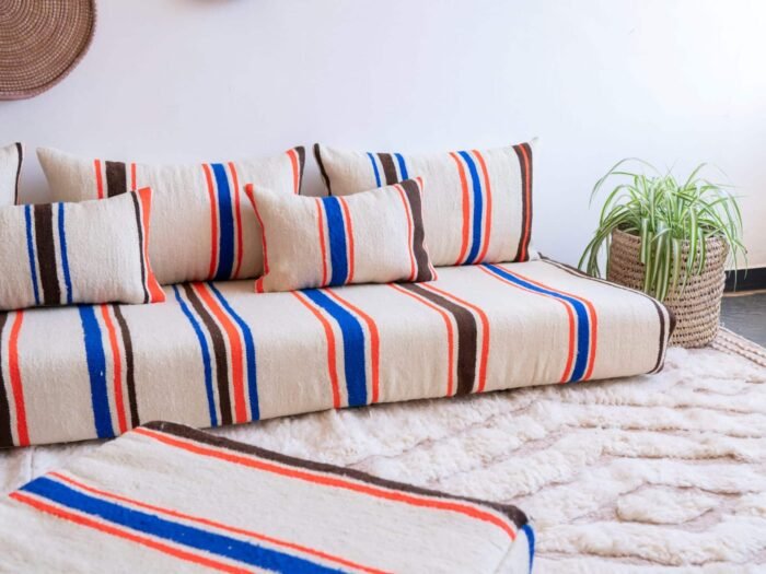 Artisan working on embroidered stripes in Moroccan wool fabric