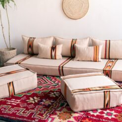 Bohemian living room featuring Moroccan floor couch set with cream and orange-black cushions