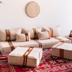 Moroccan floor couch layout with cream cushions and embroidered