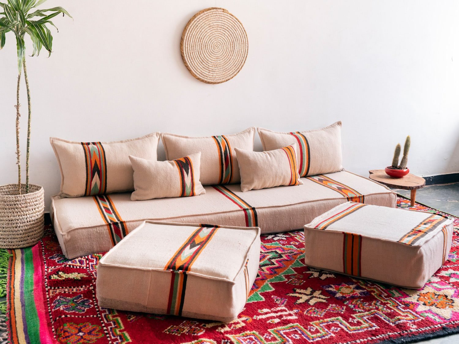 Moroccan floor couch layout with cream cushions and embroidered