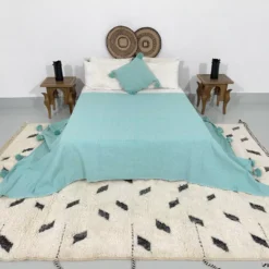 Turquoise throw blanket paired with Moroccan home decor items