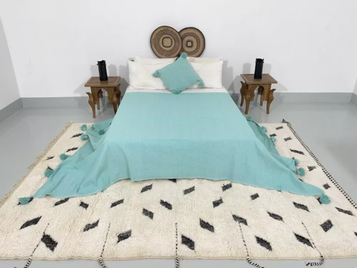 Turquoise throw blanket paired with Moroccan home decor items