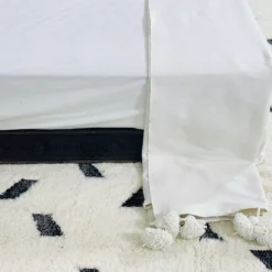 White cotton blanket paired with light boho decor accessories