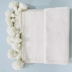 Folded Moroccan blanket in solid white cotton
