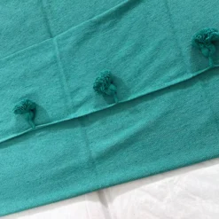 Close-up of the cotton weave texture in teal green