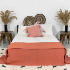Boho-style bedroom with terracotta Moroccan pompom blanket