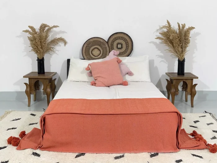 Boho-style bedroom with terracotta Moroccan pompom blanket