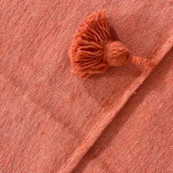 Close-up of woven cotton texture in terracotta color