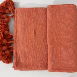Moroccan terracotta blanket folded to show sizing and texture
