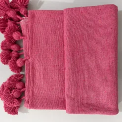 Moroccan pink cotton throw surrounded by neutral and feminine décor
