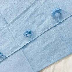 Detail of the light blue cotton weave of the Moroccan blanket