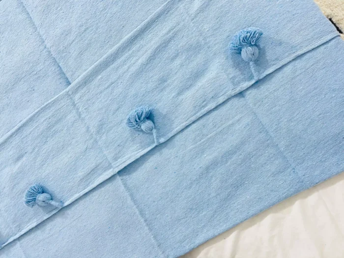 Detail of the light blue cotton weave of the Moroccan blanket