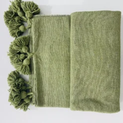 Olive green Moroccan blanket in daylight, showing subtle tones