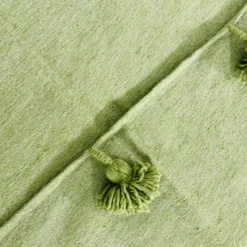 Close-up of the woven cotton texture in olive green