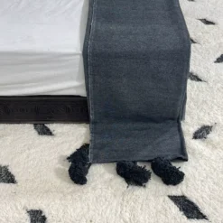 Moroccan dark grey cotton throw styled on a neutral-toned sofa