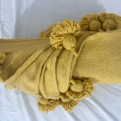 Mustard throw casually styled over reading chair