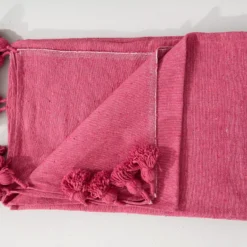 Pink cotton blanket catching natural sunlight