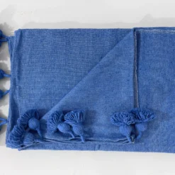 Moroccan blanket in royal blue displayed with artisan decor accessories