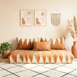 Close-up of handwoven Berber Moroccan floor sofa cover in orange tones