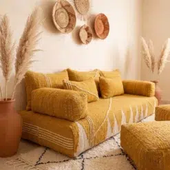 Side view of handwoven mustard Moroccan floor sofa covers with ivory details and matching pillows