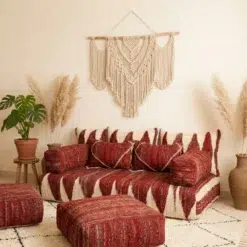 Side view of red Moroccan floor couch covers with handwoven pillows and matching armrests