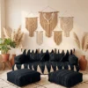 Black Moroccan floor sofa cover set with ivory patterns, matching cushions, armrests, and two poufs