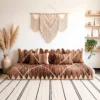 Handwoven brown and ivory Moroccan floor sofa with matching pillows in a boho living room