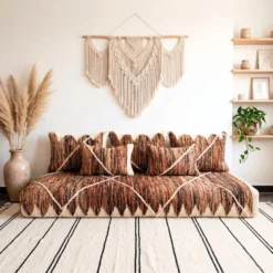 Handwoven brown and ivory Moroccan floor sofa with matching pillows in a boho living room