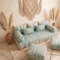 Light blue and ivory Moroccan floor sofa set viewed from above with matching floor poufs