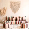 Handwoven multicolor striped Moroccan floor sofa with matching poufs and macrame wall hanging