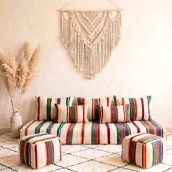 Handwoven multicolor striped Moroccan floor sofa with matching poufs and macrame wall hanging