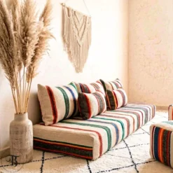 Multicolor striped Moroccan floor sofa with matching poufs and macrame wall hanging