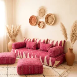 Pink and ivory Moroccan floor sofa with matching poufs and woven wall baskets