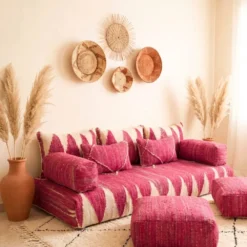 Pink and ivory Moroccan floor sofa styled with terracotta vases and pampas grass