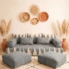 Handwoven gray and ivory Moroccan floor sofa with matching poufs and woven wall baskets