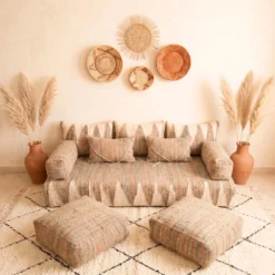 Natural beige and ivory Moroccan floor sofa with matching poufs viewed from the front