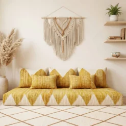 Yellow and ivory Moroccan floor sofa with matching pillows in a living room with arched shelving