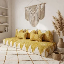 Yellow and ivory Moroccan floor sofa in a cozy corner with wooden shelves and pampas grass