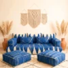 Front view of blue Moroccan floor sofa with ivory handwoven patterns and two matching poufs