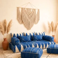 Blue Moroccan modular floor sofa with two square wool poufs in a bohemian living room