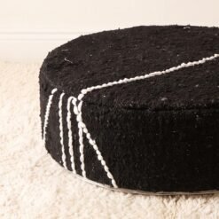 Close-up of black cotton pouf showing textured weave and raised ivory stripes